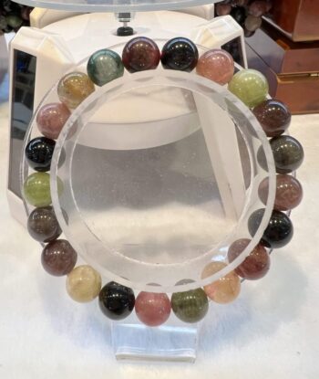 A round bracelet with different colored beads on it.