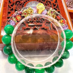 A green bracelet sitting on top of a table.