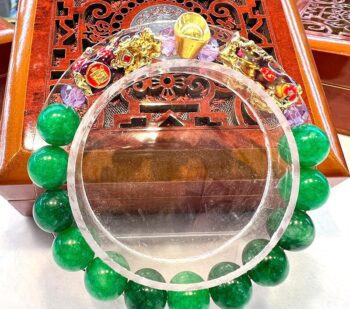 A green bracelet sitting on top of a table.