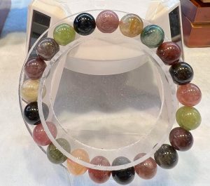 A bracelet of various colored beads on display.