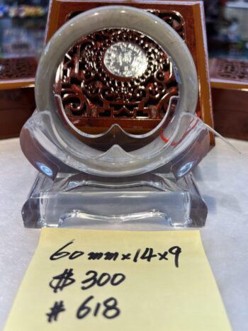 A glass clock sitting on top of a table.