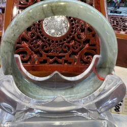 A large green jade ring sitting on top of a table.