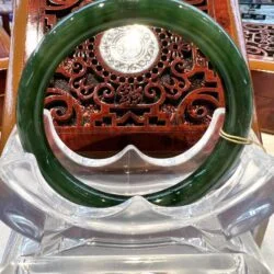 A green and white bangle sitting on top of an ice sculpture.