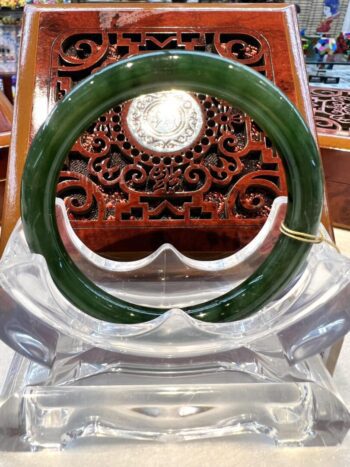 A green and white bangle sitting on top of an ice sculpture.