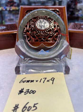 A glass clock sitting on top of a table.