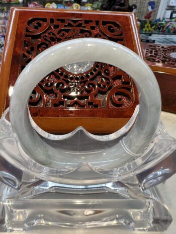 A close up of an asian style table with a white and clear glass bowl.