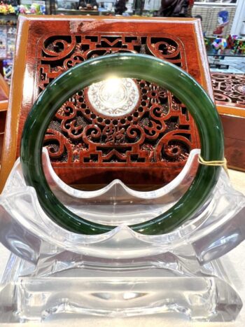 A green and white bangle sitting on top of a table.