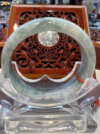 A circular glass sculpture with a wooden carving.