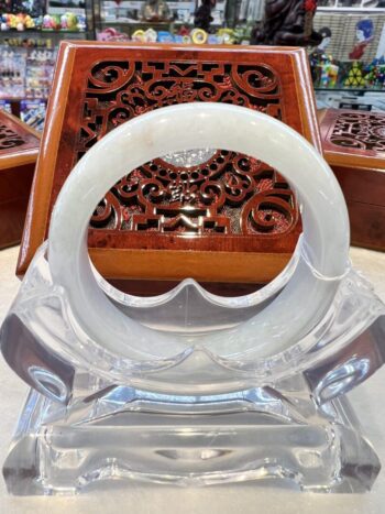 A white glass ring sitting on top of a table.