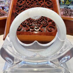 A white glass ring sitting on top of a table.