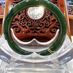 A green and white bangle sitting on top of a table.