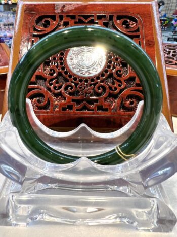 A green and white bangle sitting on top of a table.