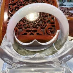 A white bangle sitting on top of a clear glass bowl.