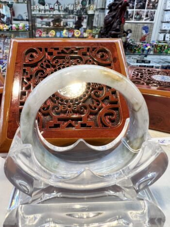 A close up of an object in front of a wooden box.