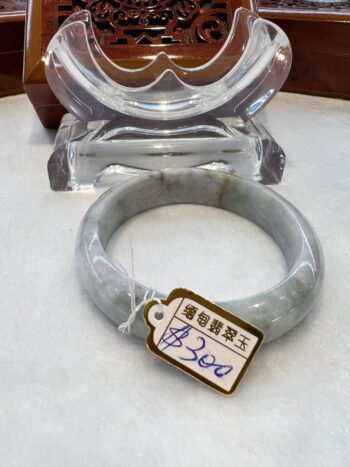 A grey stone bracelet sitting on top of a table.