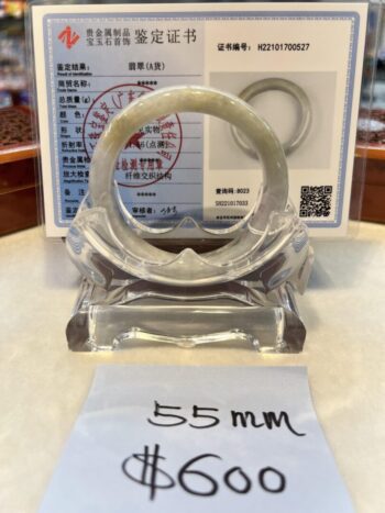 A white plastic bangle sitting on top of a table.