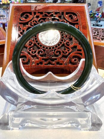 A green and clear plastic ring sitting on top of a chair.