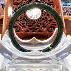 A green and clear plastic ring sitting on top of a chair.