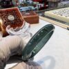 A person holding a glass plate on top of a table.