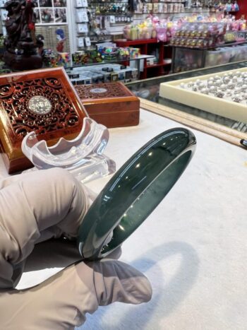 A person holding a glass plate on top of a table.