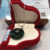 A necklace in a red box on top of a table.