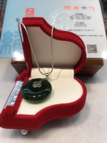 A necklace in a red box on top of a table.