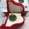 A green jade necklace in a red box.
