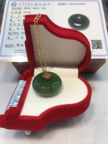 A green jade necklace in a red box.