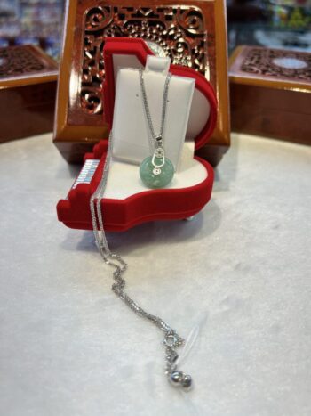 A necklace is sitting in a red box.