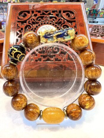 A large round bracelet with brown beads and a yellow bead.