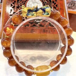 A close up of an orange bracelet on display