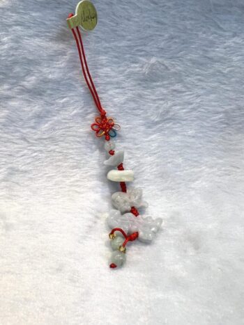 A red string with white beads and other items.