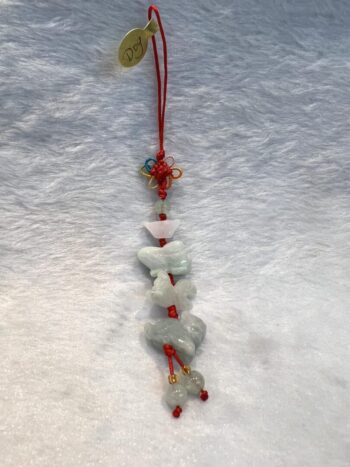 A string of white and red beads hanging on a red cord.