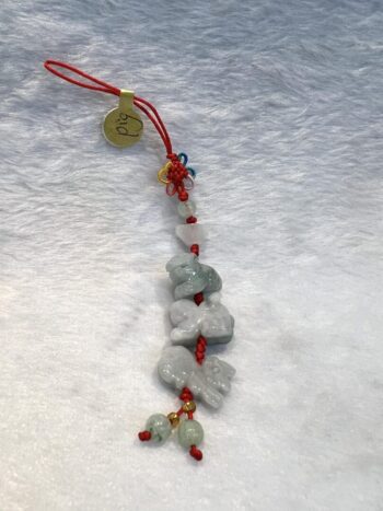 A string of beads with a tag hanging from it.