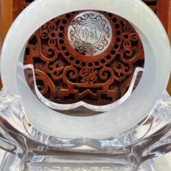 A white plate sitting on top of a clear glass table.