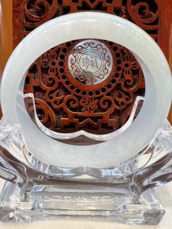 A white plate sitting on top of a clear glass table.