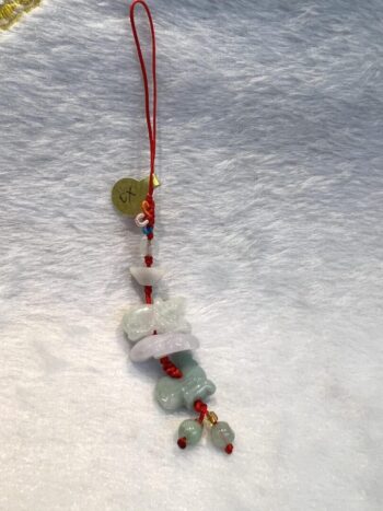 A long necklace with red cord and beads.