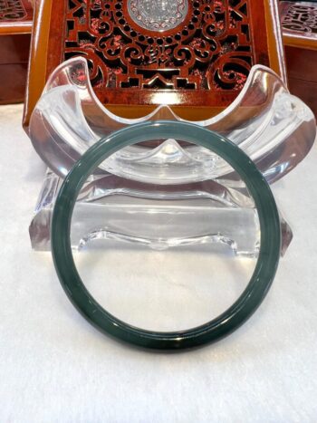 A green bangle sitting on top of a table.