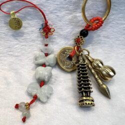 A pair of key chains with various charms and beads.