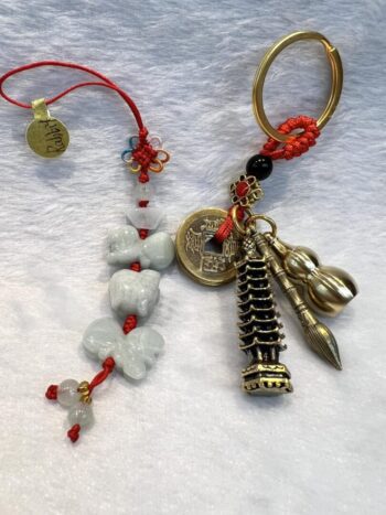 A pair of key chains with various charms and beads.