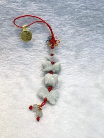 A red and white bracelet with some small beads