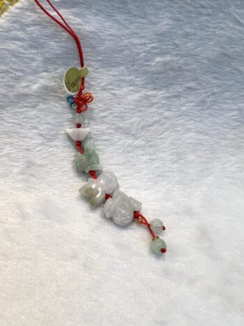 A string of beads is hanging on the floor.