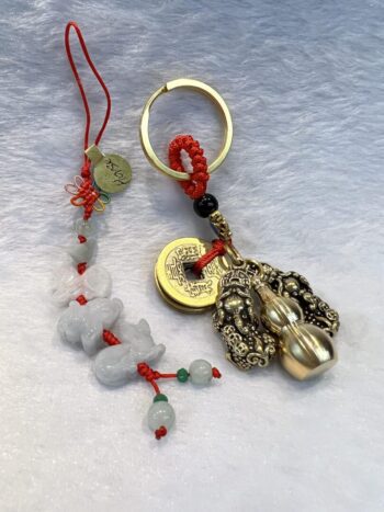 A key chain with a coin and some beads