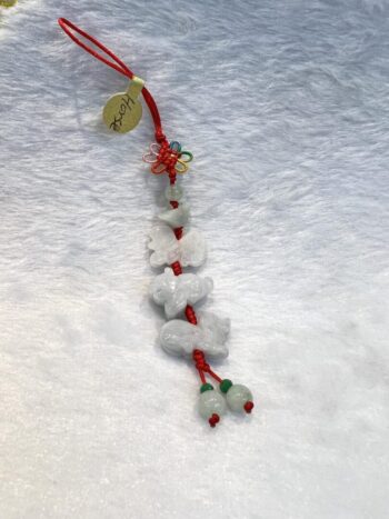 A string of white stones with green leaves on them.