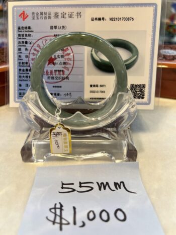 A green jade bangle sitting on top of a counter.