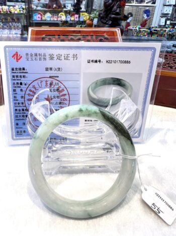 A green jade bangle is sitting on the table.