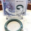 A green bangle sitting on top of a table.