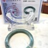 A green bangle sitting on top of a table.