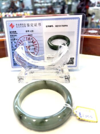 A green jade bangle is on display for sale.