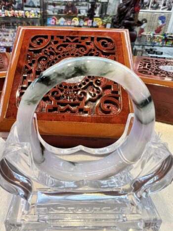 A close up of an asian style box with a glass bowl